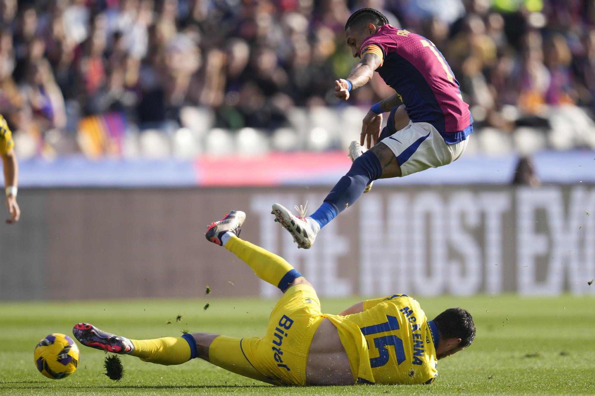 FC Barcelona's Raphinha (top) vies for the ball with UD Las Palmas' Scott McKenna during their LaLiga EA Sports match at the olympic stadium Lluis Companys in Barcelona, north-eastern Spain, 30 November 2024. EFE/ Enric Fontcuberta