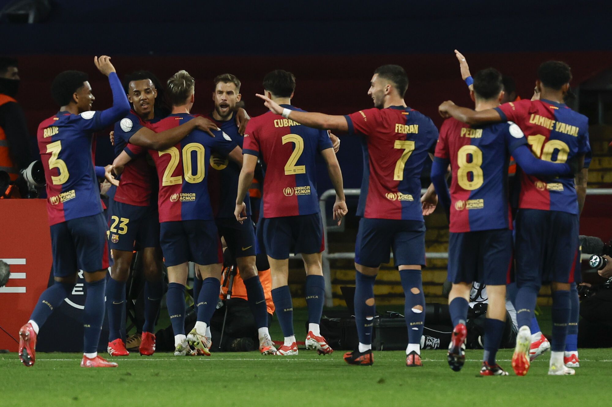 Barcelona players celebrate after a goal during a Spanish Copa del Rey or King's Cup, the semi-final soccer match between Barcelona and Atletico Madrid in Barcelona, Spain, Tuesday, Feb. 25, 2025. AP Photo/Joan Monfort)