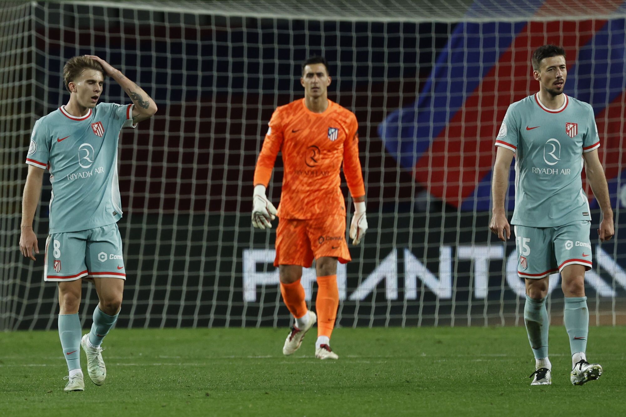 Atletico Madrid players stand dejected after Barcelona scored their third goal during a Spanish Copa del Rey, or King's Cup, the semi-final soccer match between Barcelona and Atletico Madrid in Barcelona, Spain, Tuesday, Feb. 25, 2025. AP Photo/Joan Monfort)